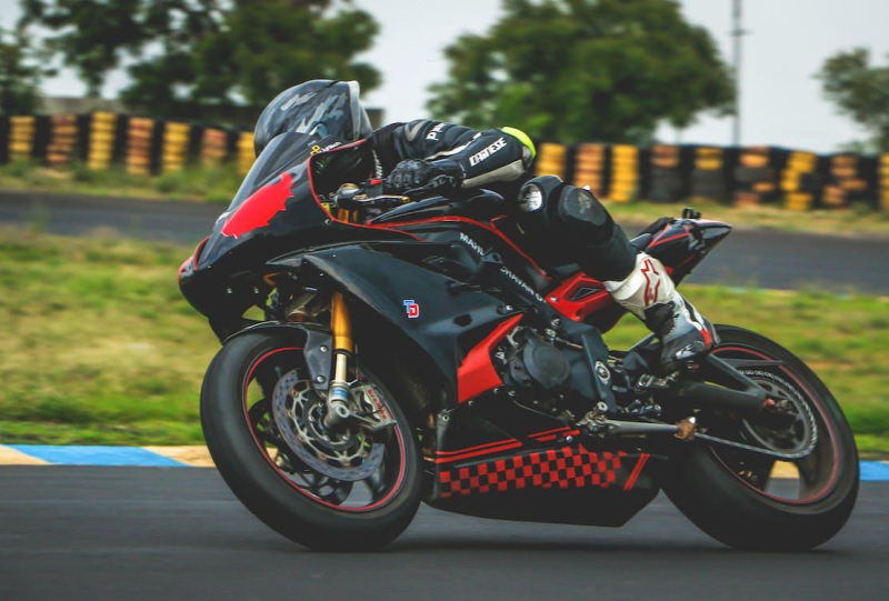 Black and red motorcycle racing on track